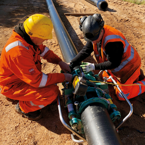 Men Working on Pump Pipeline Men Working on Pump Pipeline